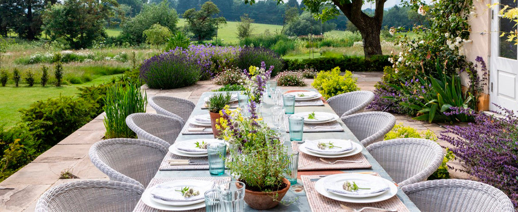 Elegant outdoor dining area in the garden with elegant dining chairs