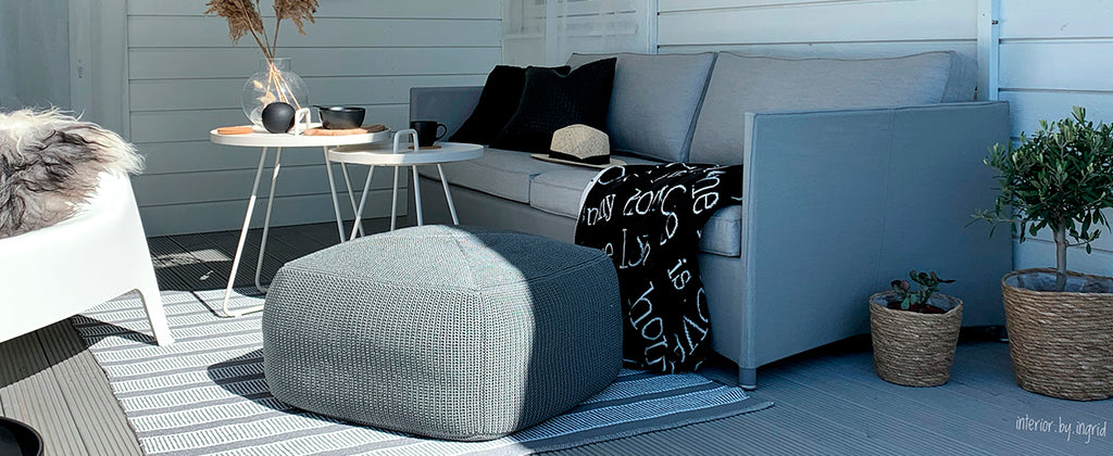 Cosy outdoor lounge sofa with modern footstool and minimalist side table