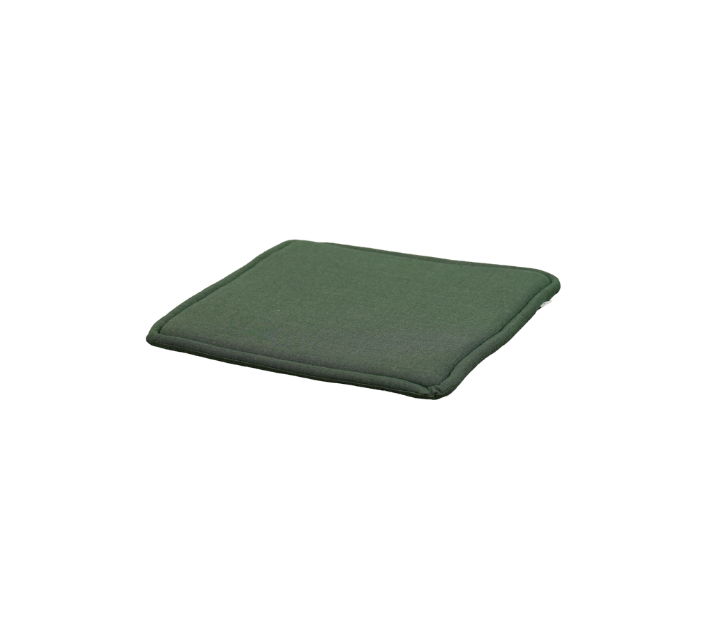 Lichtgroene kussen op een vlakke oppervlakte geplaatst.