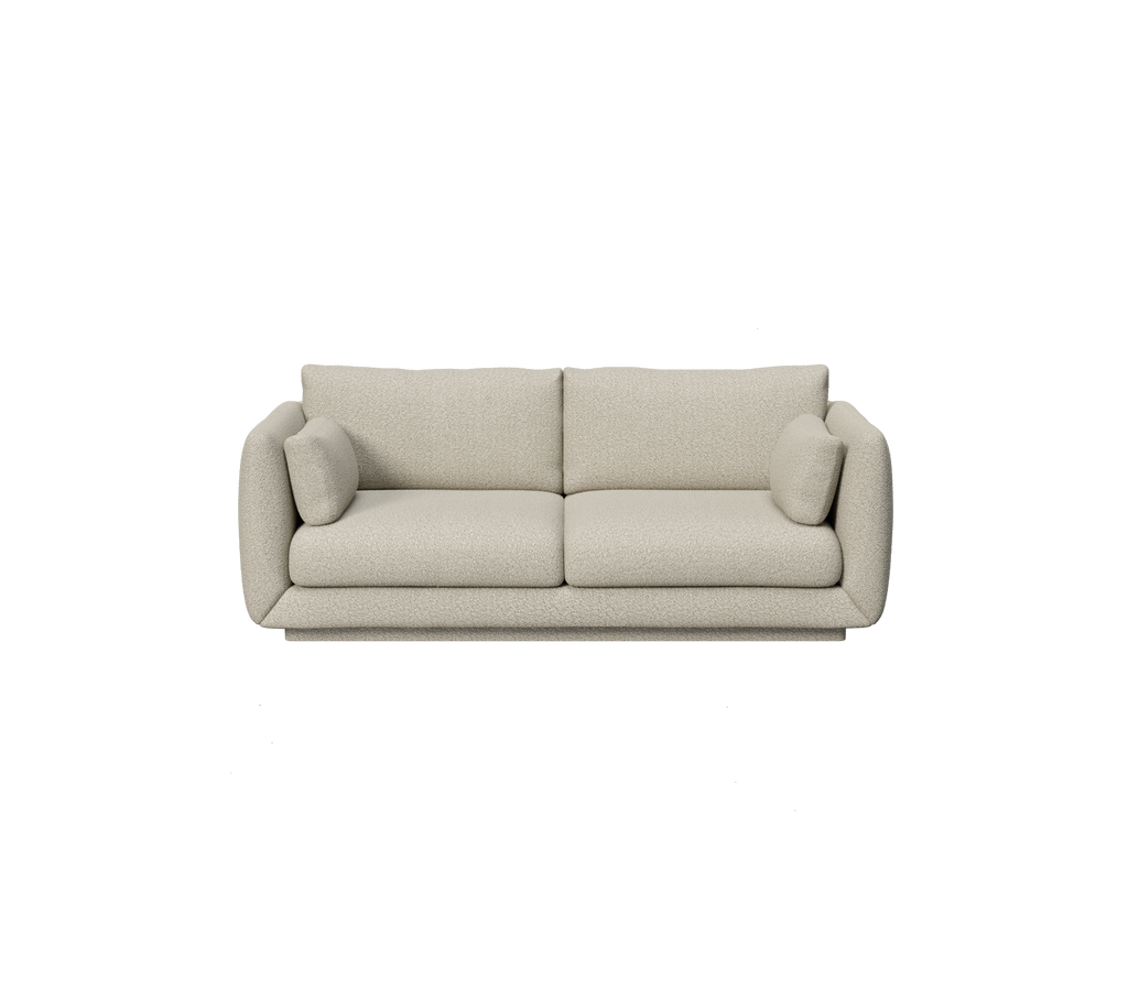 Lichtbruine bank met ronde kussens in een modern design.