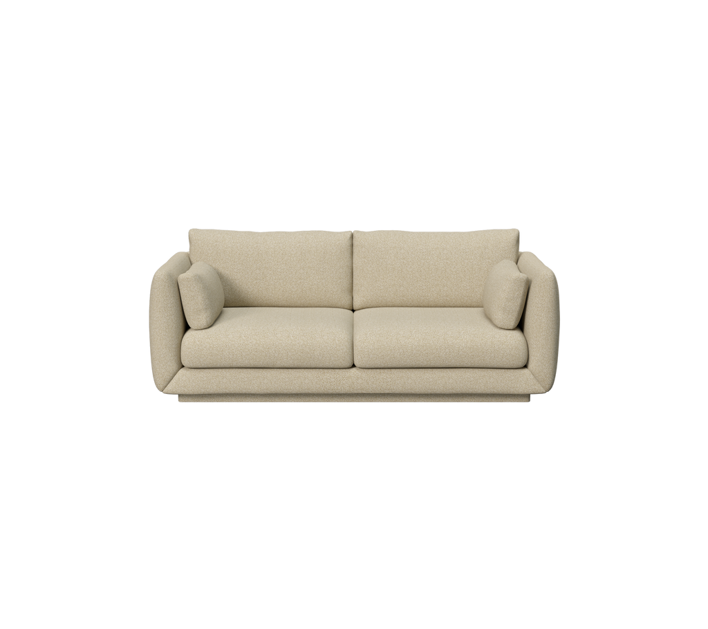 Lichtbruin sofa met afgeronde hoeken en twee kussens.