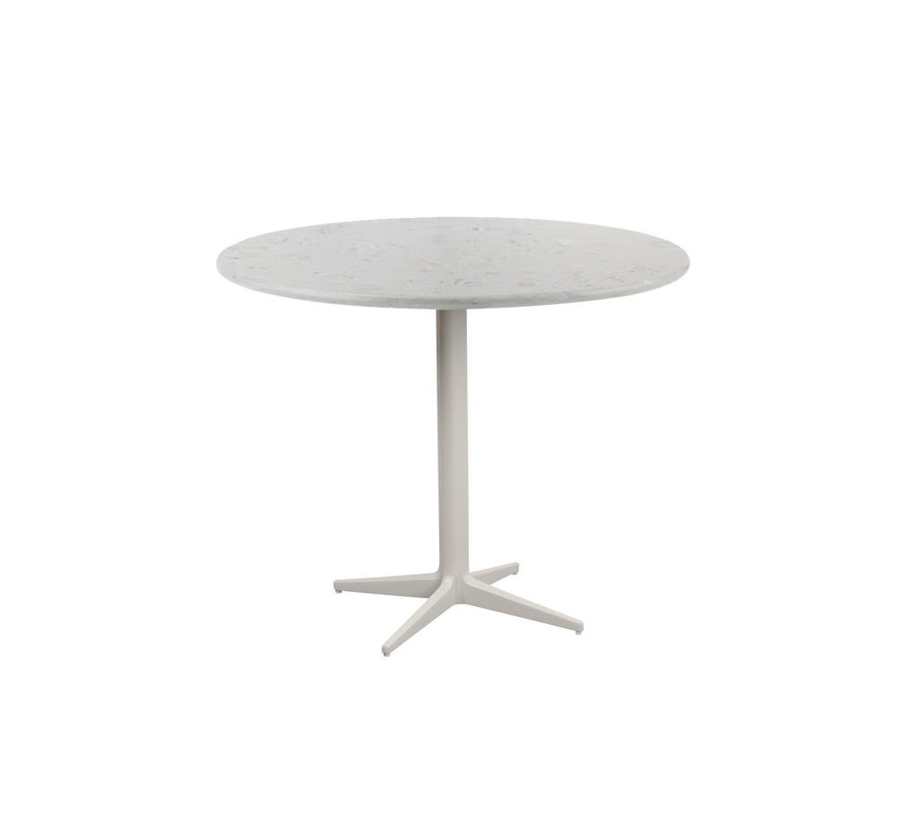 Ronde tafel met een eenvoudig ontwerp en een witte basis.